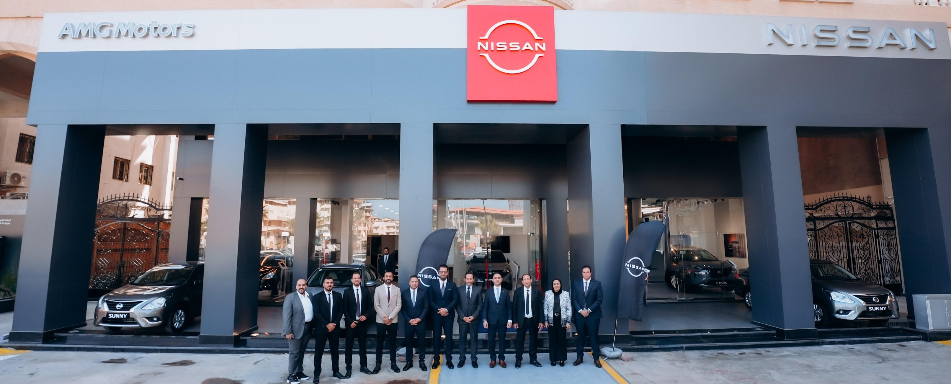 Nissan AMG showroom exterior with the team